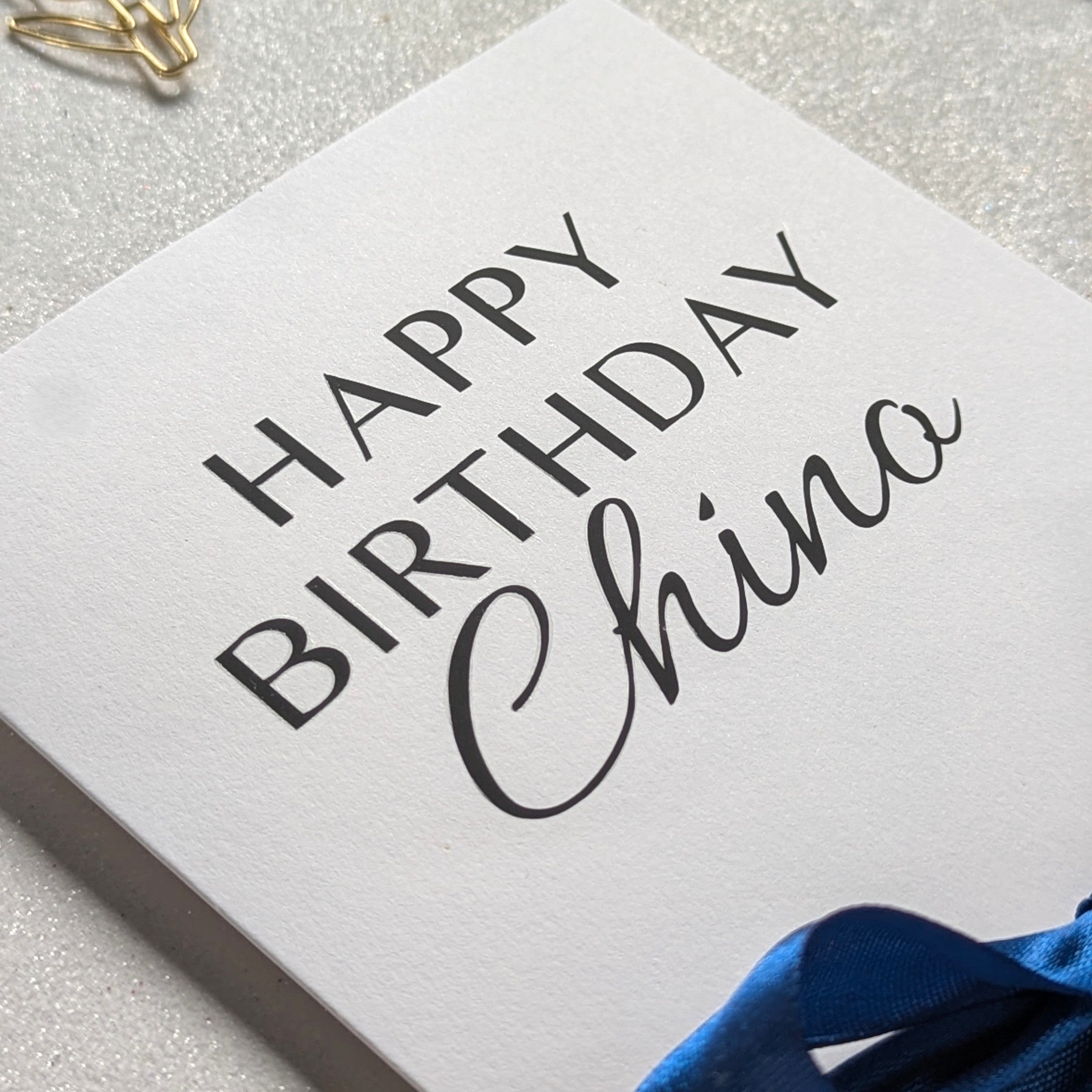 Close up of the personalised Birthday money card for giving a gift voucher with 'happy birthday chino' in black vinyl