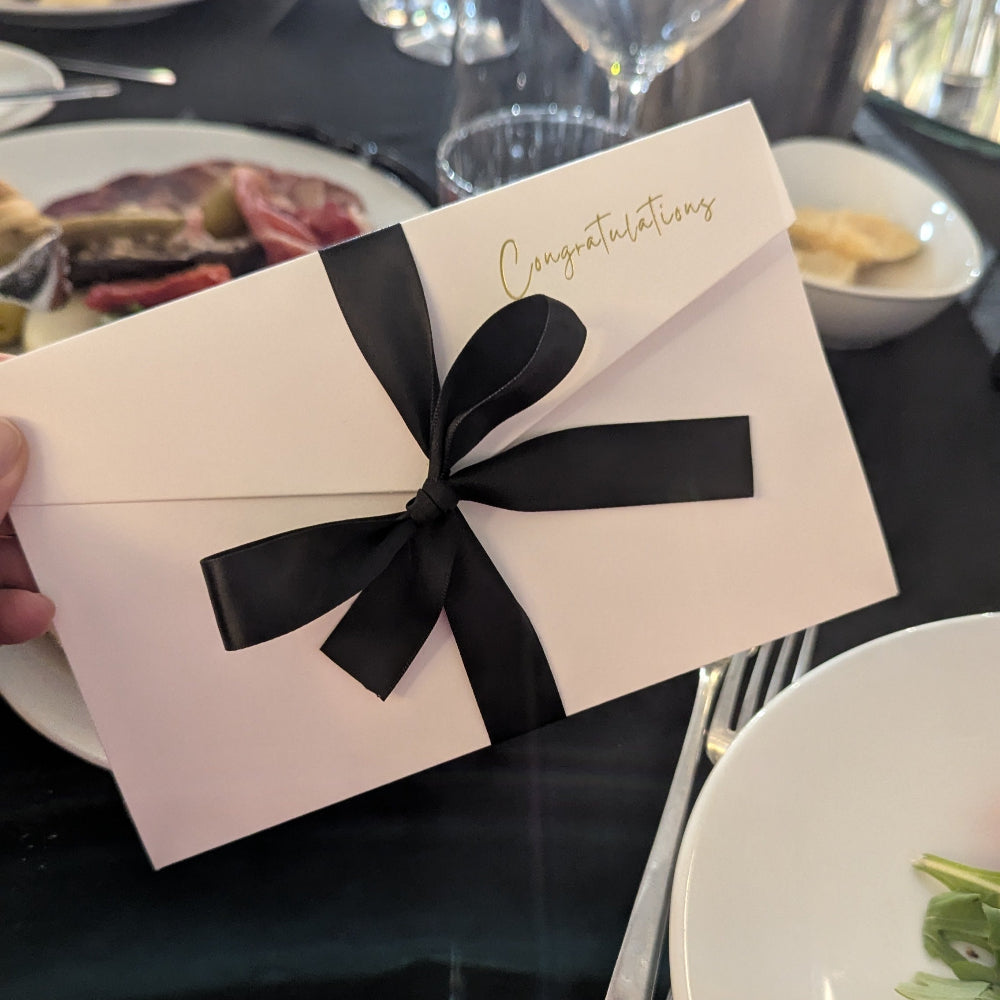 White Congratulations wedding money envelope at wedding table