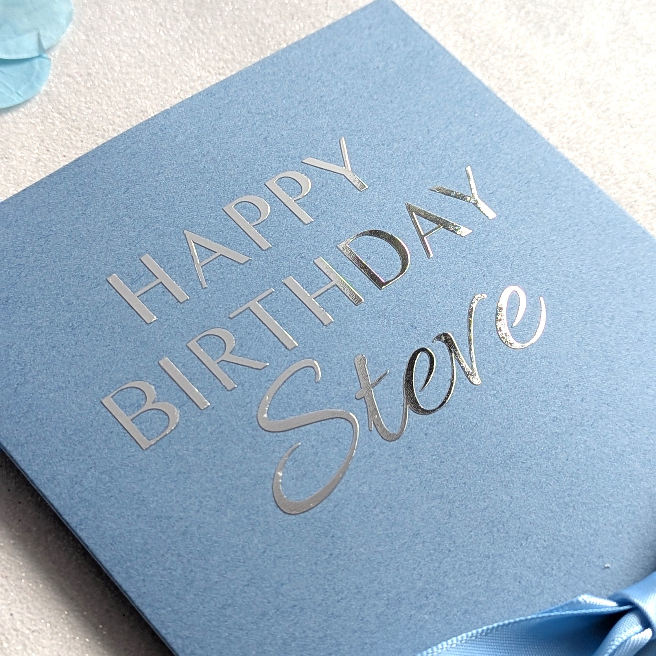 Blue Personalised Money Birthday card with blue ribbon with Happy Birthday Steve in Silver vinyl close up