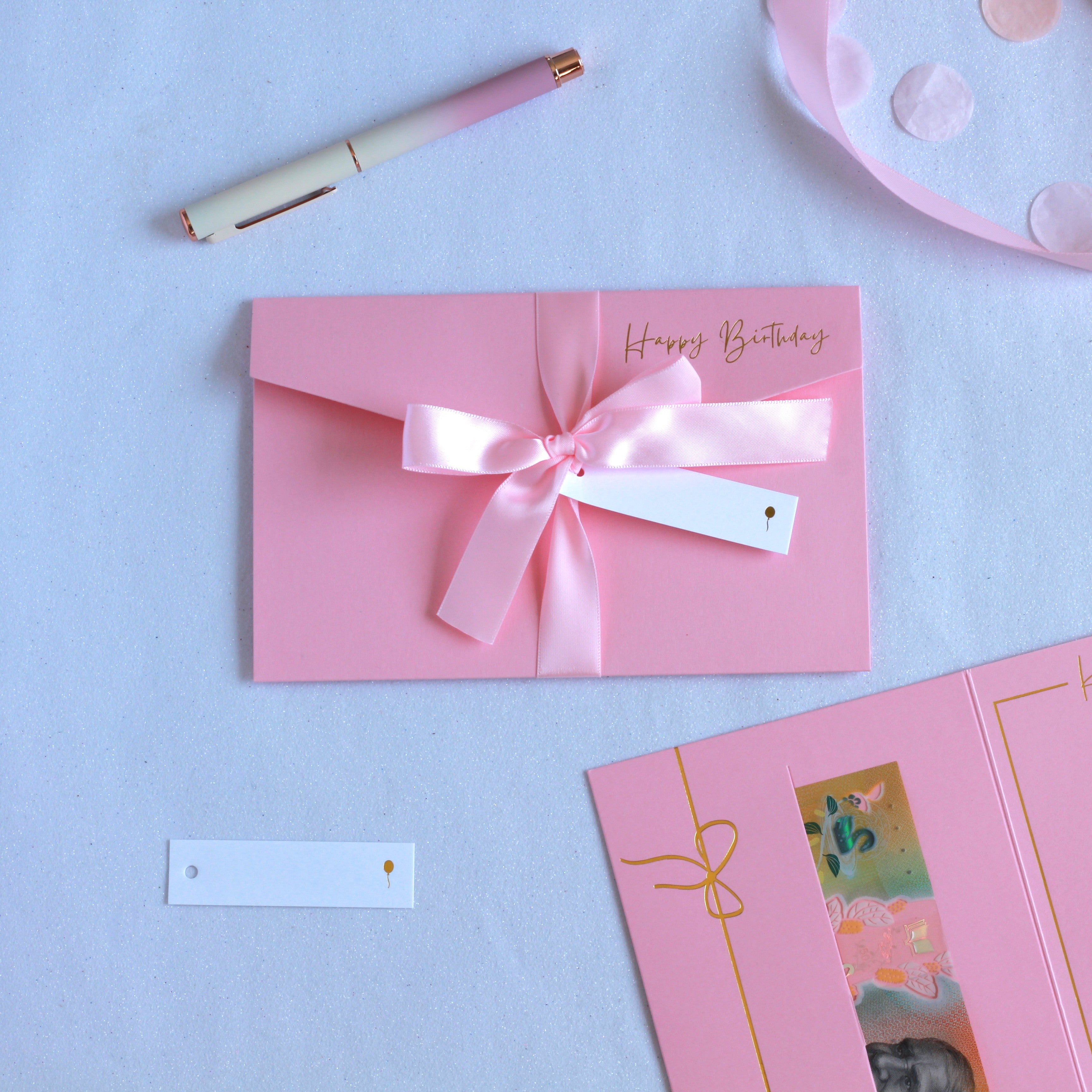 Beautiful pink luxury birthday money wallet with ribbon and white tag