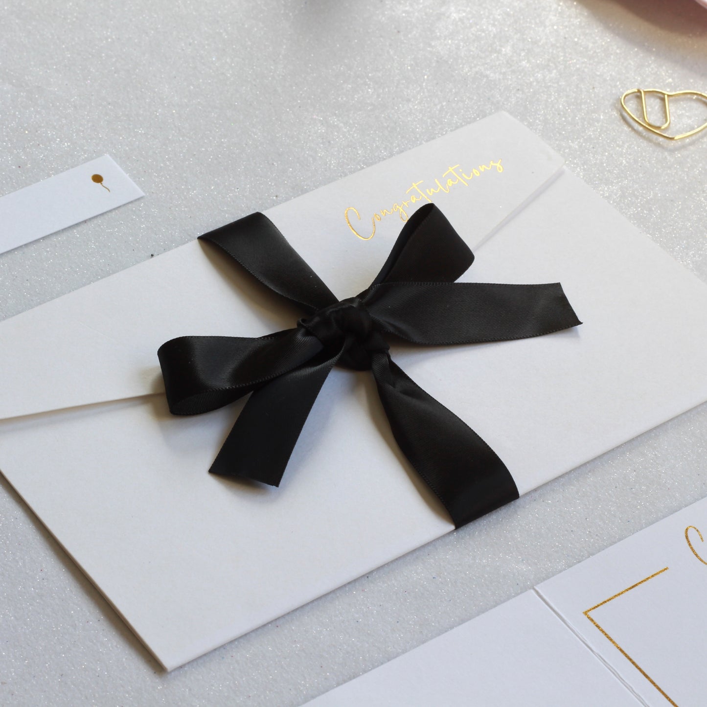Black ribbon on white greeting card with money pocket