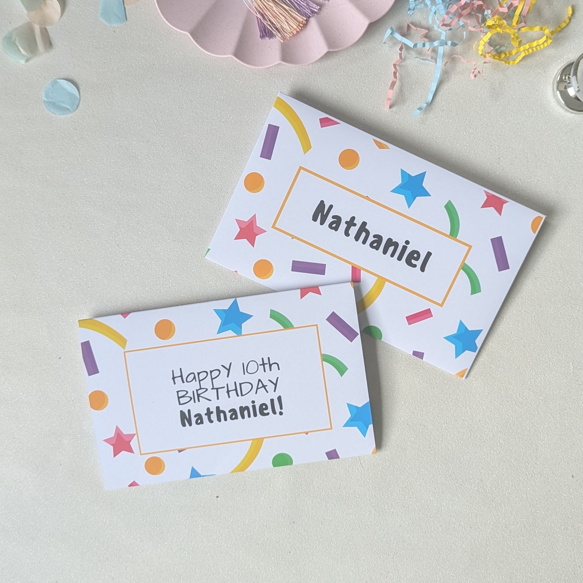 Custom illustrated birthday card envelope with matching confetti graphics and recipient's name printed on 200gsm premium heavyweight cardstock.