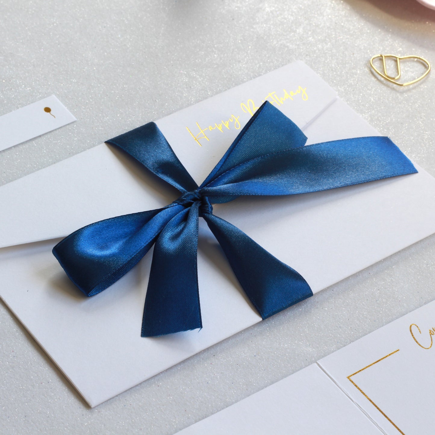 Dark Blue ribbon on white greeting card with money pocket