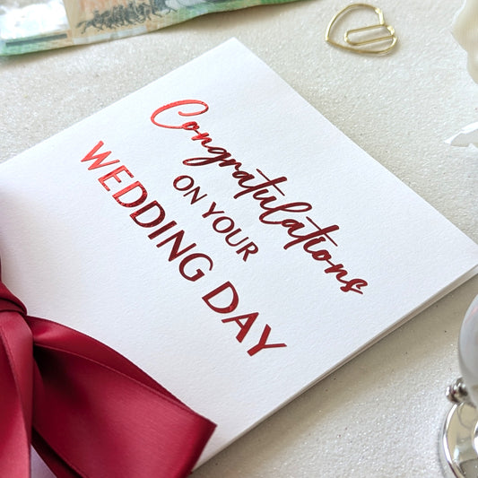 Chinese money envelope for wedding, hongbao, with red congratulations on your wedding day and red ribbon