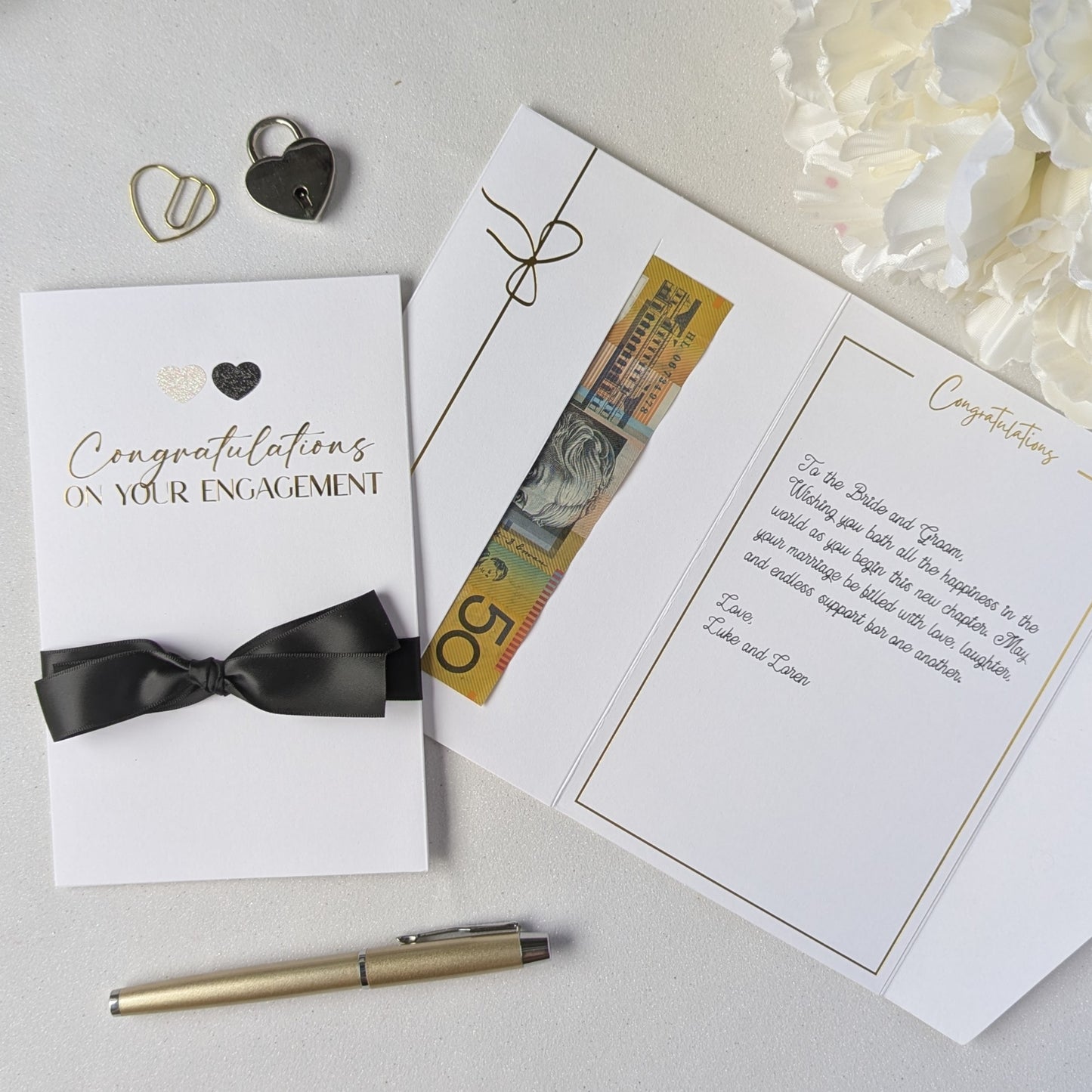Congratulations on your engagement gift envelope with black and white glitter hearts and black satin ribbon with gift in the gift envelope. Luxury Engagement Card
