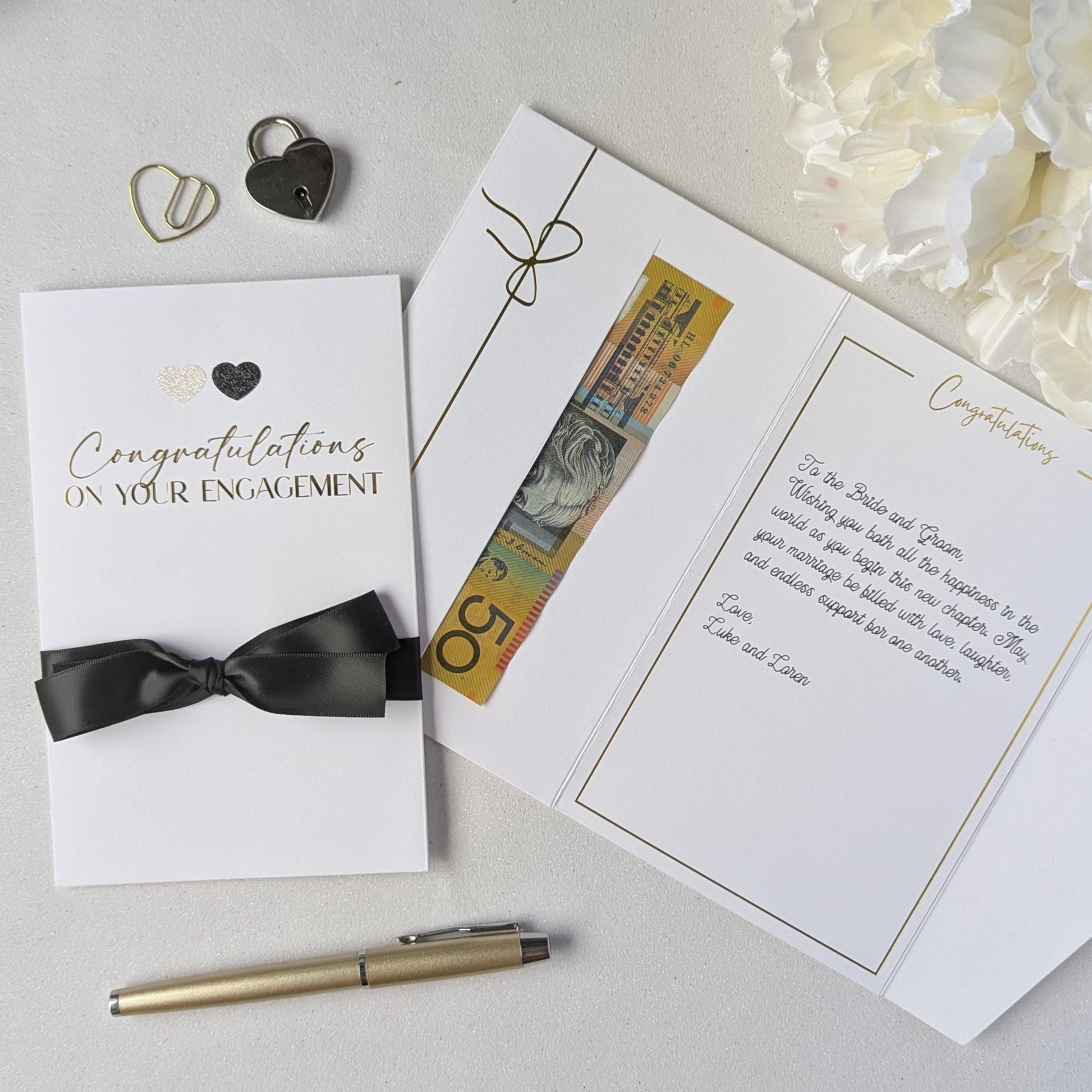 Congratulations on your engagement gift envelope with black and white glitter hearts and black satin ribbon with gift in the gift envelope. Luxury Engagement Card