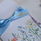 Floral Mothers money card with personalised blue ribbon with mum on it