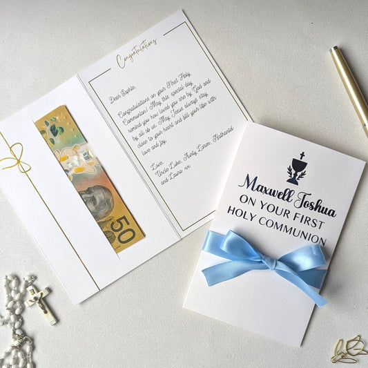 Holy communion money gift envelope greeting card with blue personlaised On your first holy communion with blue satin ribbon and pocket for the cash gift with message written inside the card