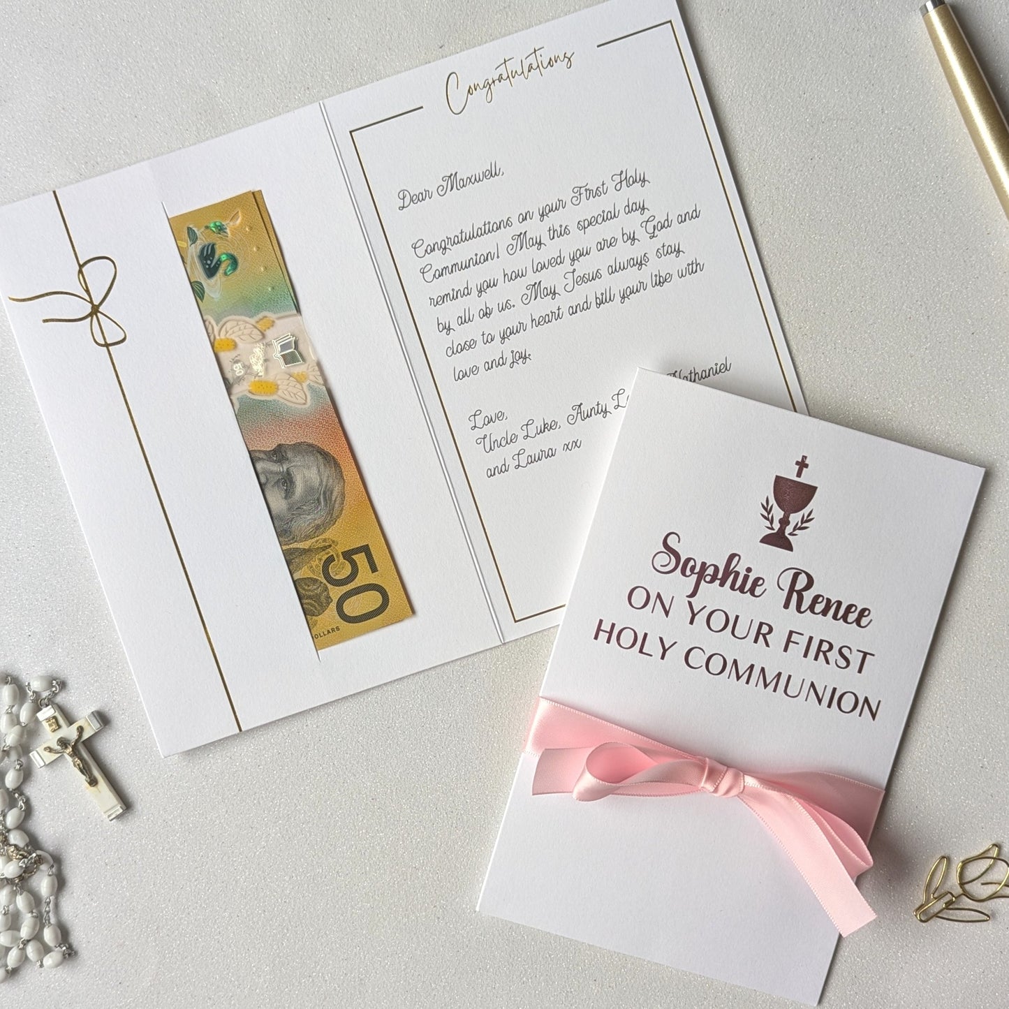 Holy communion money gift envelope greeting card with pink personlaised On your first holy communion with pink satin ribbon and pocket for the cash gift with message written inside the card