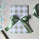 Keepsake baby shower gender neutral green card for giving money or voucher with personalised ribbon 'Baby Kohler' written on it. 