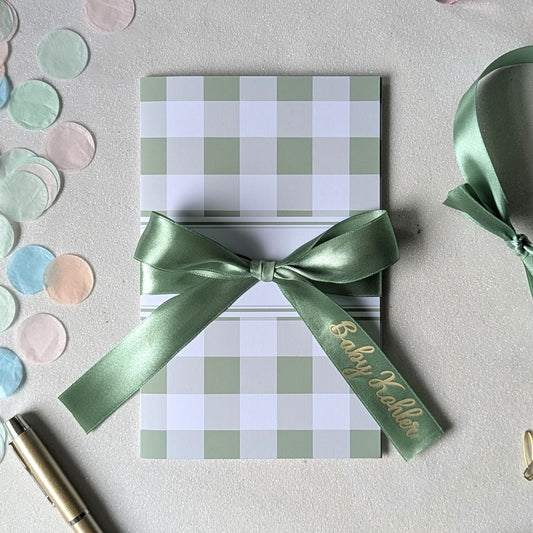 Keepsake baby shower gender neutral green card for giving money or voucher with personalised ribbon 'Baby Kohler' written on it. 