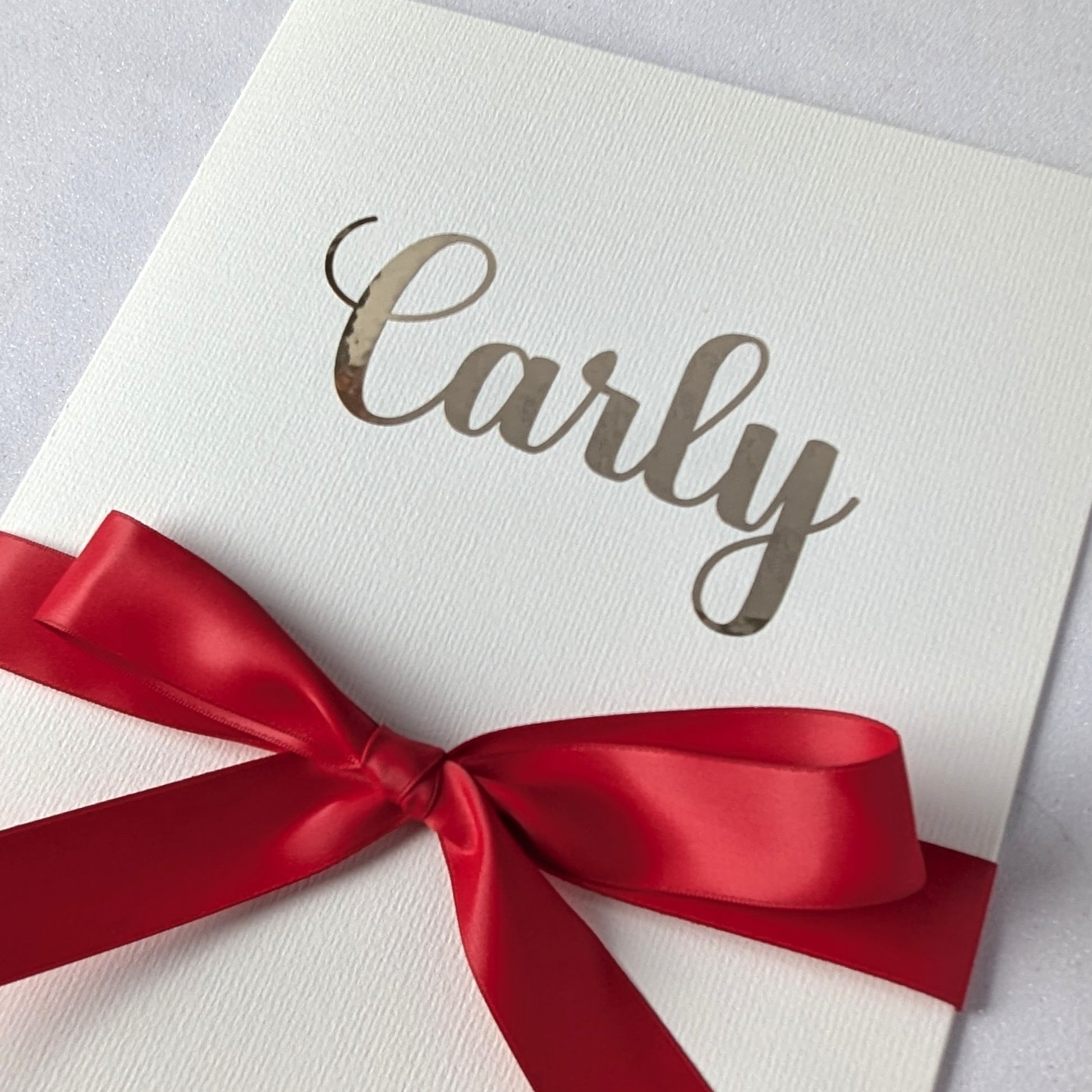 Large Personalised A4 greeting card with carly on the front and red satin ribbon