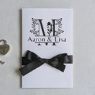 Monogram Personalised White wedding card with money pocket close up with Black vinyl monogram of Aaron and Lisa with a large floral M