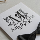 Monogram Personalised White wedding card with money pocket close up with Black vinyl monogram of Aaron and Lisa with a large floral M