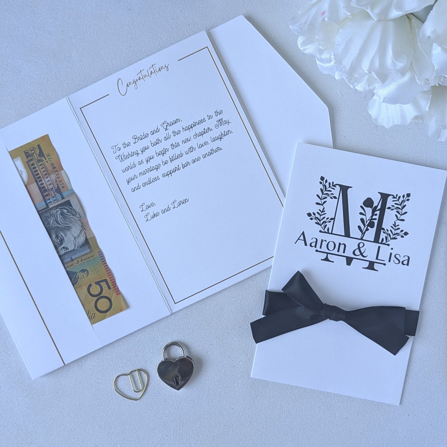 Monogram Personalised White wedding card with money pocket close up with Black vinyl monogram of Aaron and Lisa with a large floral M