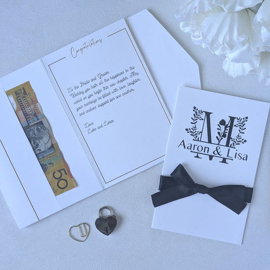 Monogram Personalised White wedding card with money pocket close up with Black vinyl monogram of Aaron and Lisa with a large floral M