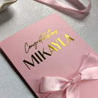 Close up of Pink bridal shower gift card holder showing the fine detail of "Congratulations Mikayla" written in gold foil
