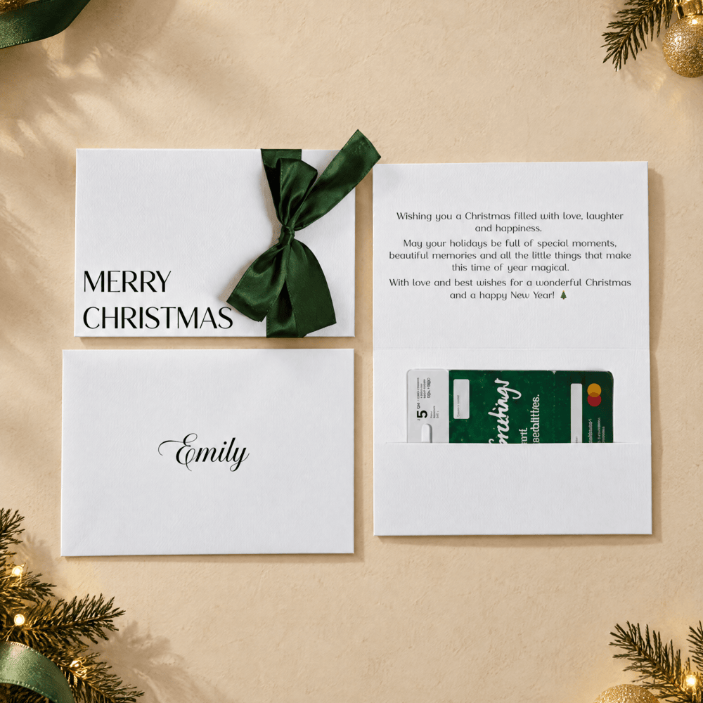 christmas card with merry christmas printed in black ink and a green satin ribbon. Custom message printed inside the card and recipients name printed on the envelope. this card has a pocket for the gift card or voucher