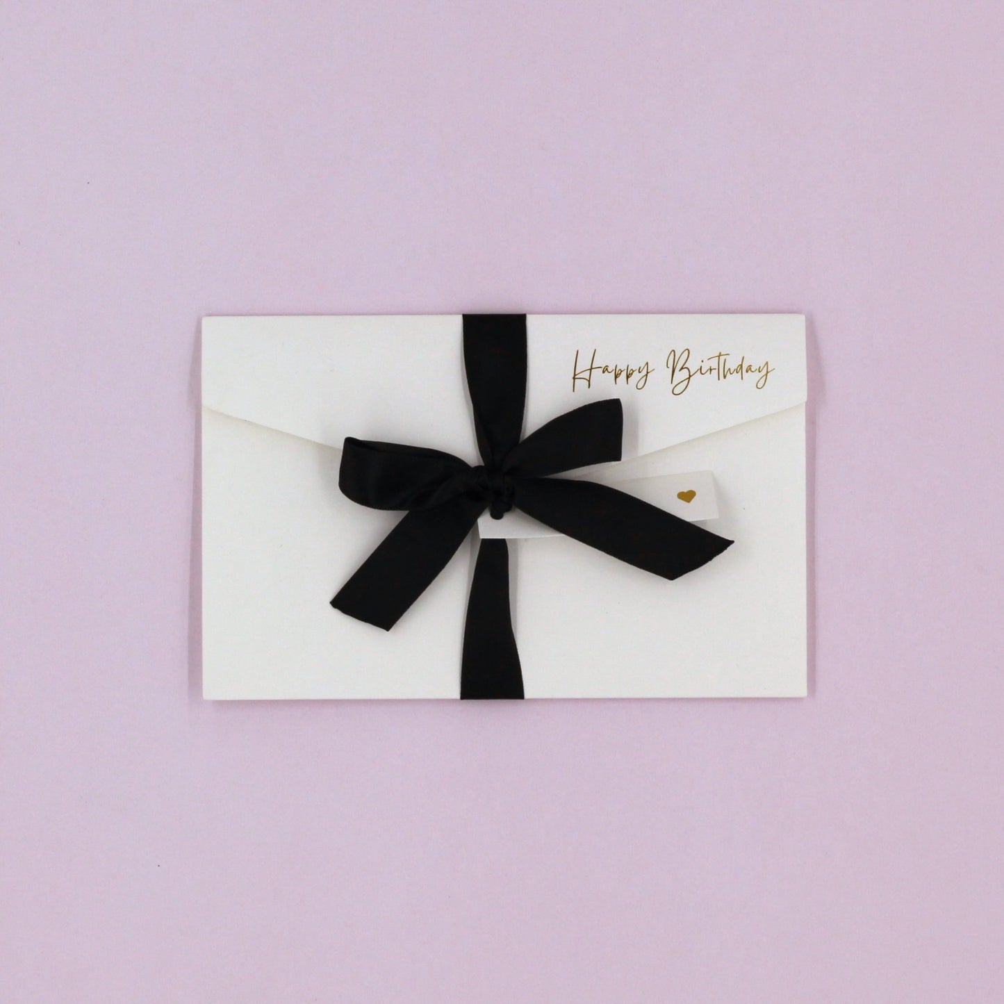 White happy birthday greeting card with black ribbon and white name tag