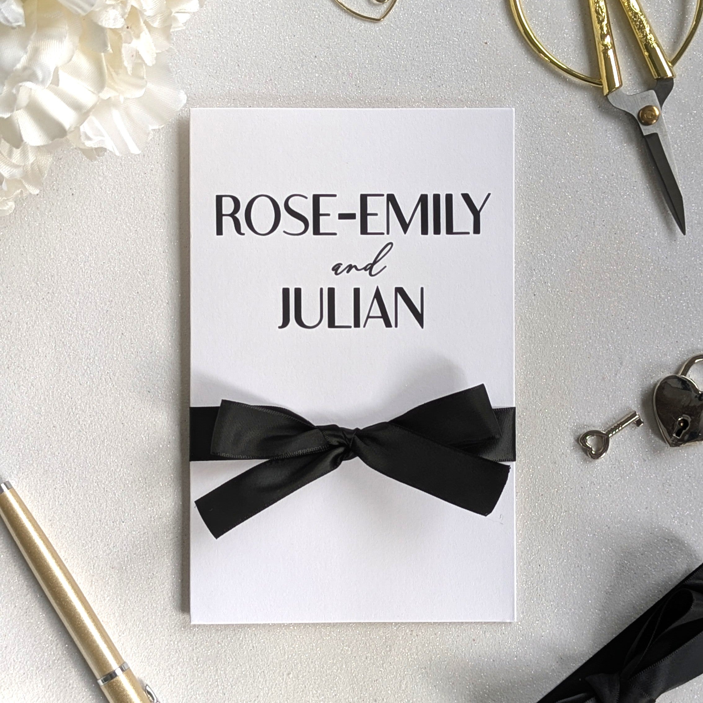 White wedding money card personalised with "Rose-Email and Julian" matte black names with a black ribbon