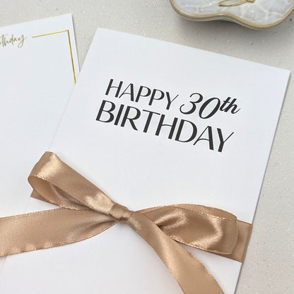 Close up of Happy 30th Birthday Money Envelope for gift card with gold satin ribbon