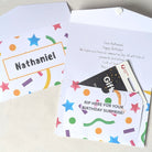 Close-up of a perforated "Rip-Open" security pocket on a personalised birthday card, showing a gift card being revealed through the tear-away strip.